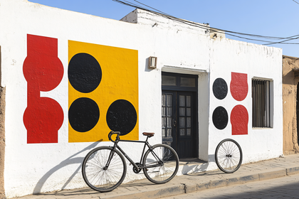 Bicycle Leaning Against a Wall with Geometric Art