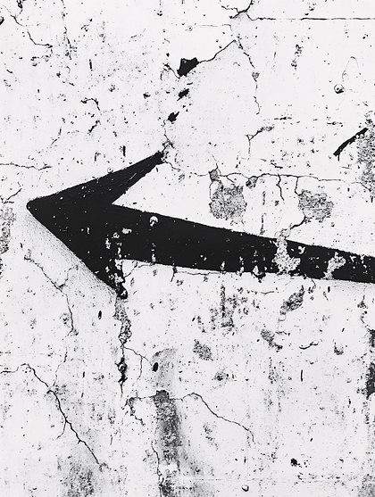 Black Arrow On Cracked White Wall
