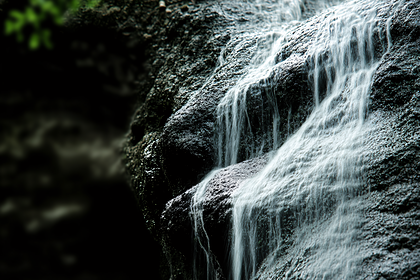 Cascading Waterfall On Dark Rocks