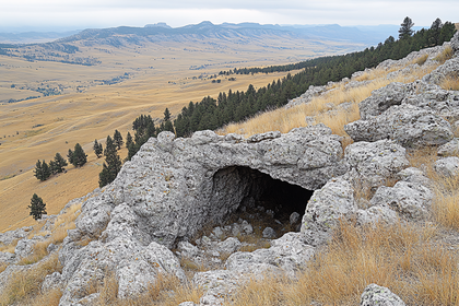 Cave Entrance in Rocky Hillside Landscape