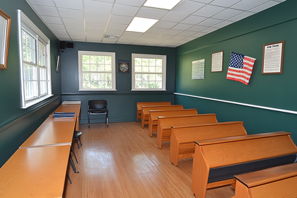 Classroom Interior with Wooden Desks and American Flag