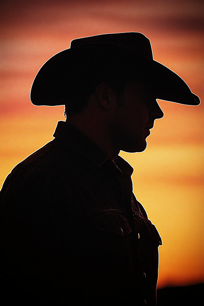 Cowboy Silhouette At Sunset
