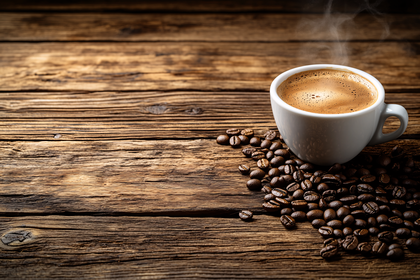 Cup Of Coffee With Beans On Wooden Table