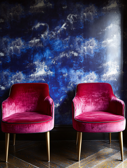 Elegant Pink Velvet Chairs Against Blue Textured Wall
