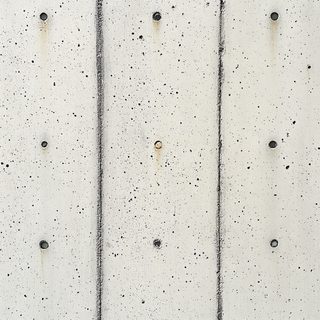 Gray Concrete Wall Texture with Formwork Marks and Circular Holes