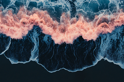 Pink Wave Crashing on Dark Sand