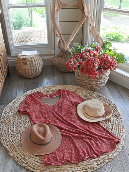 Red Dress And Hats On Straw Mat