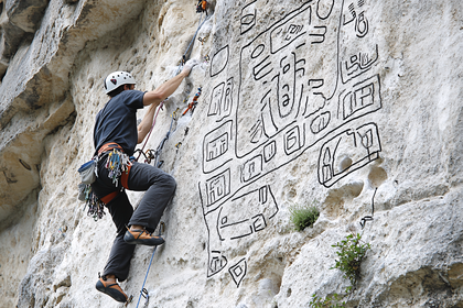 Rock Climber Ascending Wall with Abstract Drawings