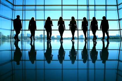 Silhouetted Business People Looking Out Window