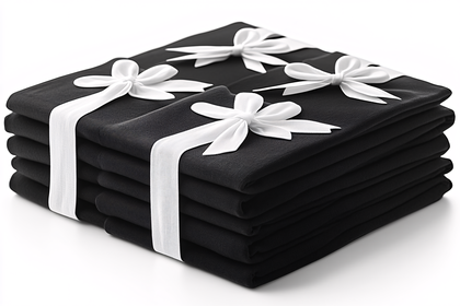 Stack Of Black Napkins Tied With White Ribbons
