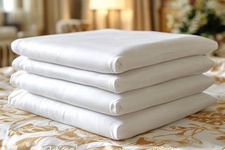 Stack Of Folded White Sheets
