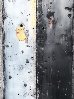 Textured Concrete Wall with Paint Patches