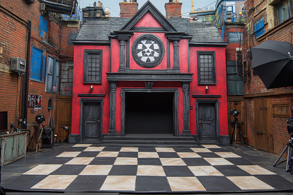 Theatrical Stage Set with Red Building Facade