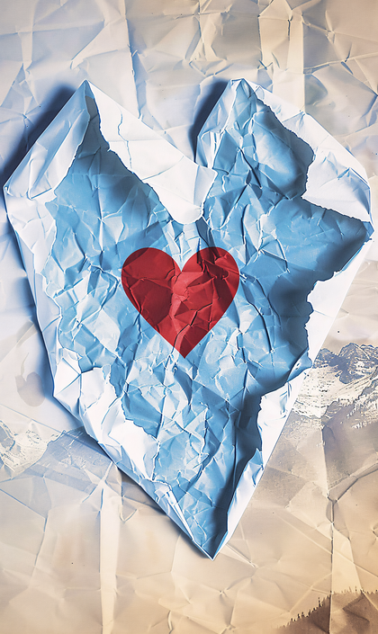 Torn Paper Heart Reveals Mountain Landscape