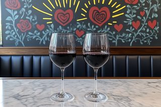 Two Glasses of Red Wine on Marble Table