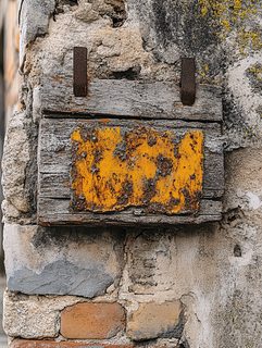 Weathered Sign On Brick Wall
