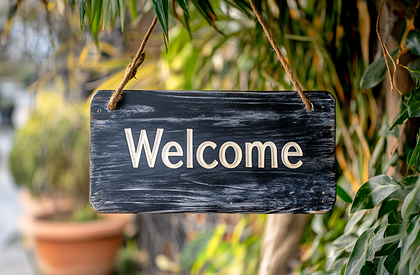 Welcome Sign Hanging In Garden