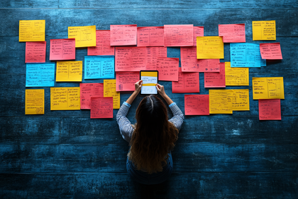 Woman Reviewing Sticky Notes On Tablet