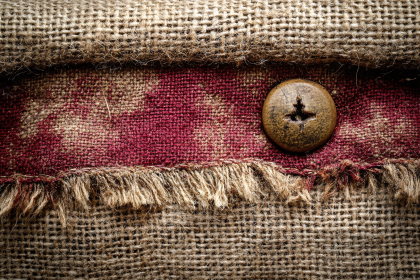 Wooden Button on Burlap Fabric
