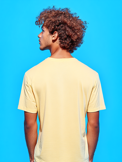 Young Man With Curly Hair In Yellow T-Shirt Back View